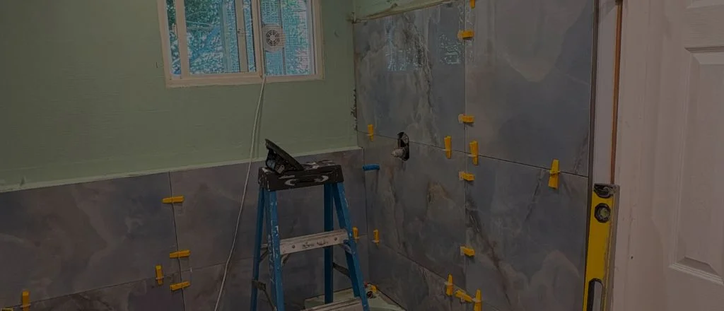 A bathroom mid-renovation with wall tiling in progress